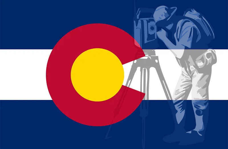Colorado flag with land surveyor looking through total station