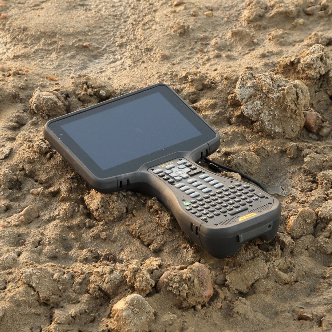 Trimble TSC710 Rugged Controller with keyboard in sandy terrain