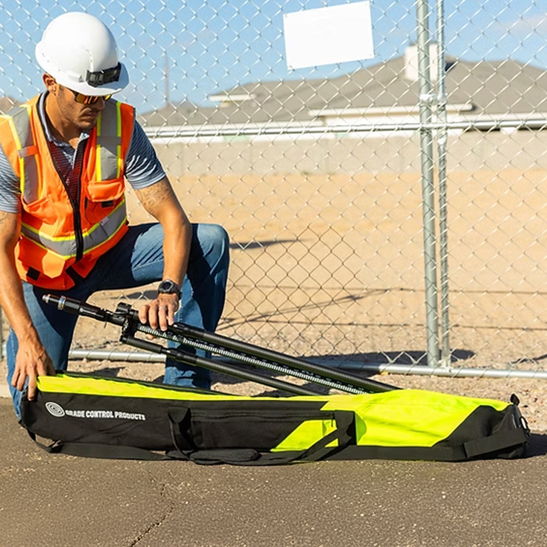 Person in safety gear unpacking rod and bipod from reinforced storage bag